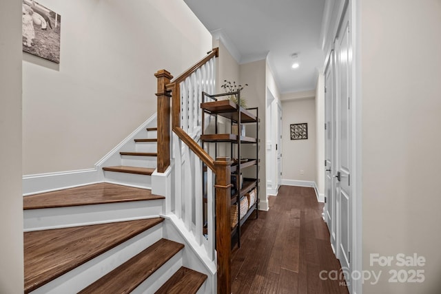 staircase featuring wood-type flooring and ornamental molding