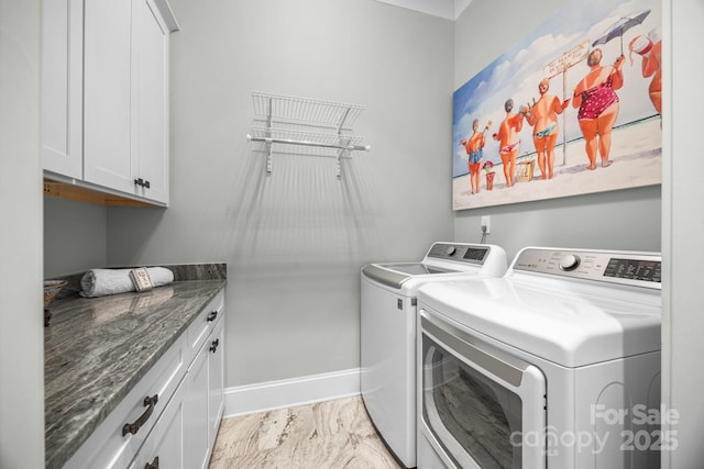 washroom featuring cabinets and independent washer and dryer