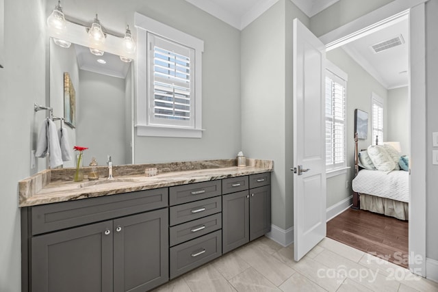 bathroom featuring crown molding and vanity