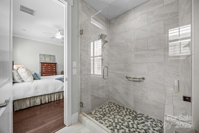 bathroom featuring wood-type flooring, ceiling fan, and a shower with shower door