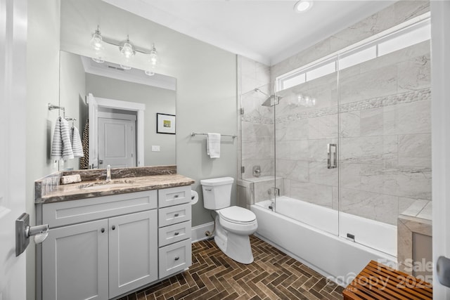 full bathroom with toilet, vanity, and shower / bath combination with glass door