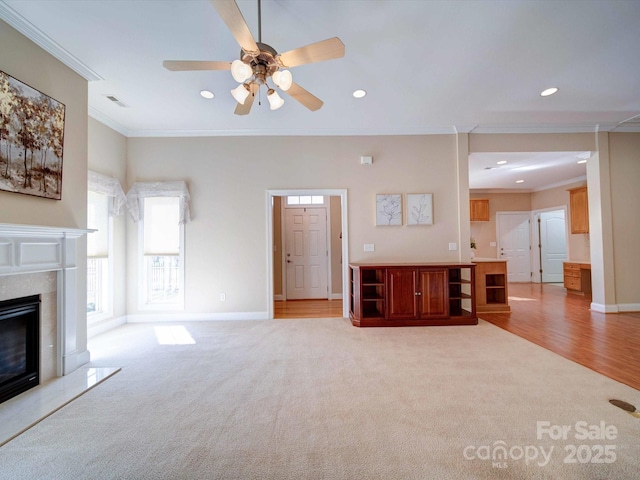 unfurnished living room featuring recessed lighting, light colored carpet, and a high end fireplace