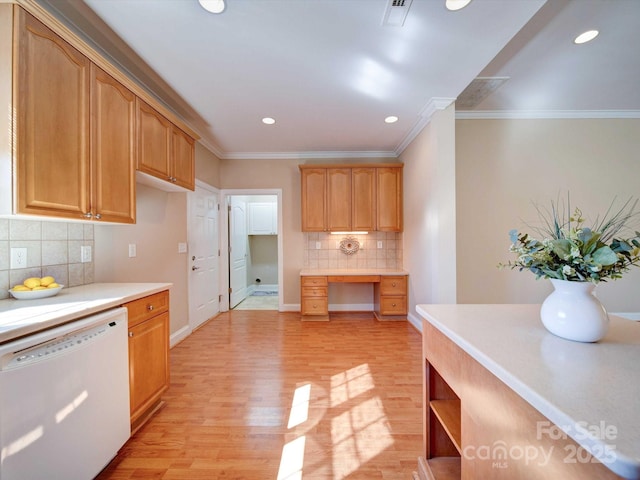 kitchen with light countertops, white dishwasher, built in desk, and light wood-type flooring