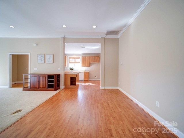 unfurnished living room featuring ornamental molding and light wood-type flooring