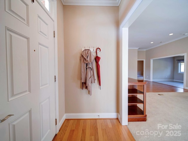 corridor featuring crown molding and light hardwood / wood-style flooring