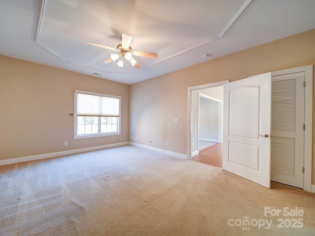 unfurnished room featuring light colored carpet and ceiling fan