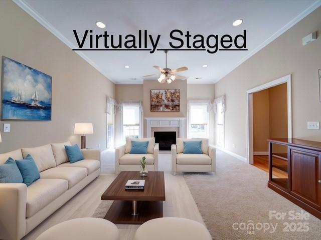 living room with recessed lighting, a fireplace, crown molding, and ceiling fan