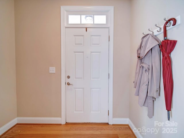 foyer entrance with baseboards and light wood-type flooring