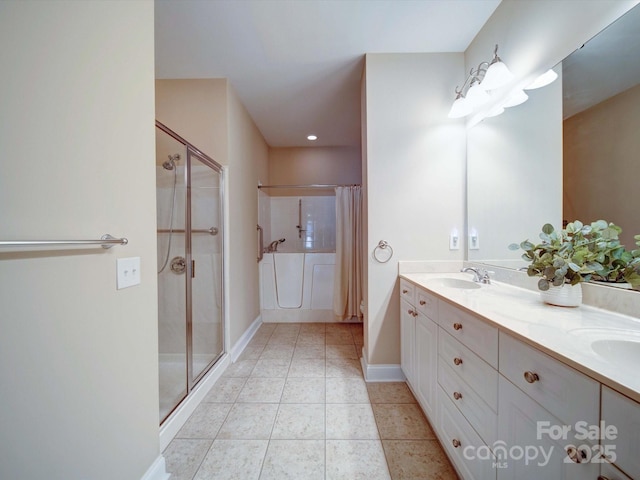 bathroom featuring tile patterned flooring, a shower stall, double vanity, and a sink