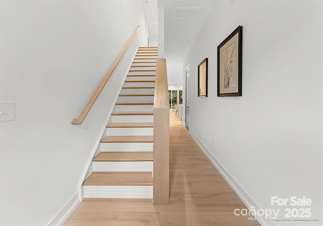 stairs with hardwood / wood-style floors