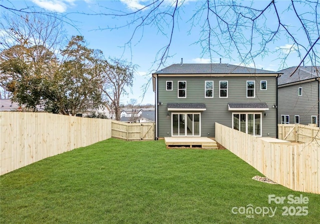 rear view of property with a deck and a lawn