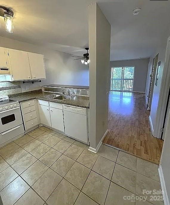 kitchen with sink, white cabinets, light tile patterned floors, ceiling fan, and white appliances