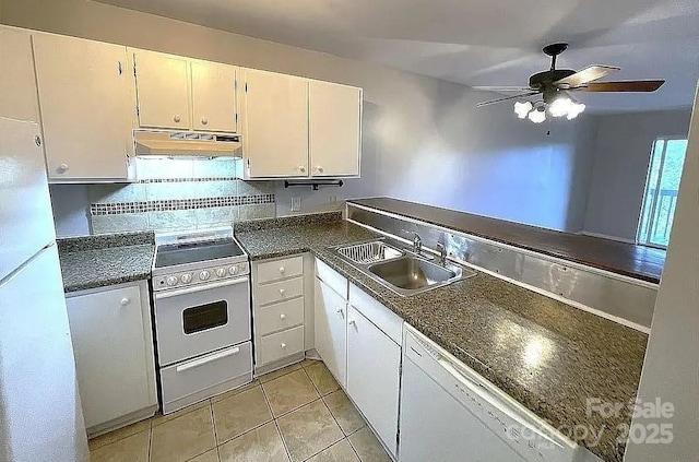 kitchen with sink, white appliances, light tile patterned floors, white cabinets, and decorative backsplash