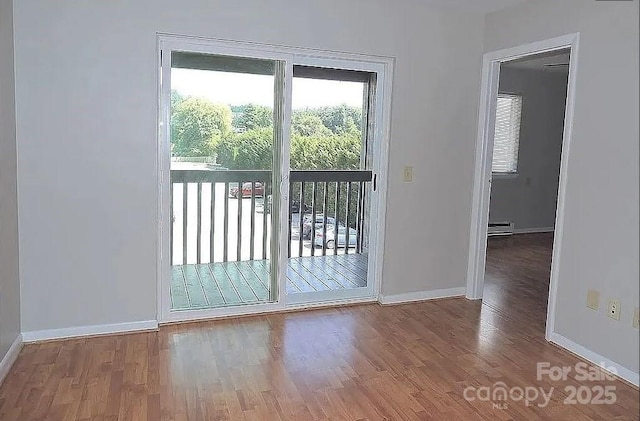 doorway featuring wood-type flooring and baseboard heating