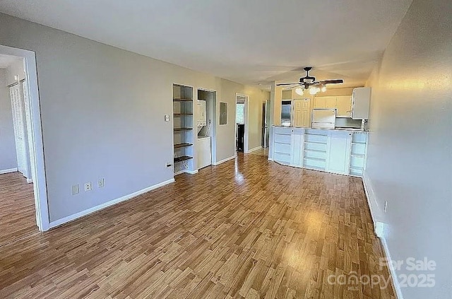 unfurnished living room with light hardwood / wood-style flooring and ceiling fan