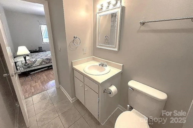 bathroom with vanity, toilet, and tile patterned flooring