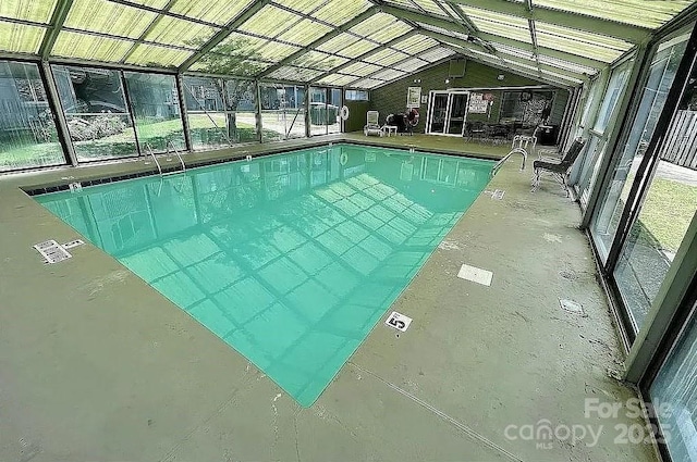 view of swimming pool featuring a lanai