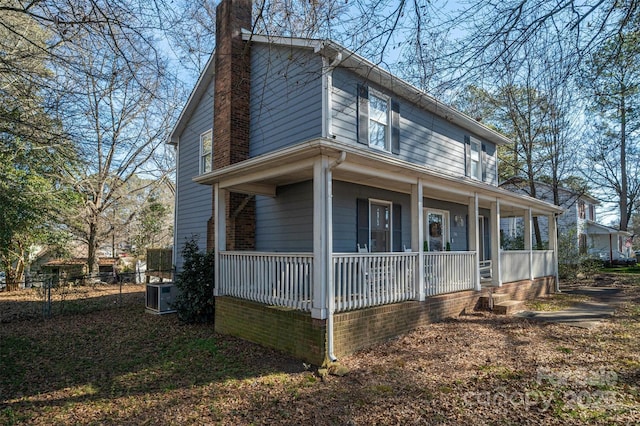 view of front facade featuring central AC and covered porch