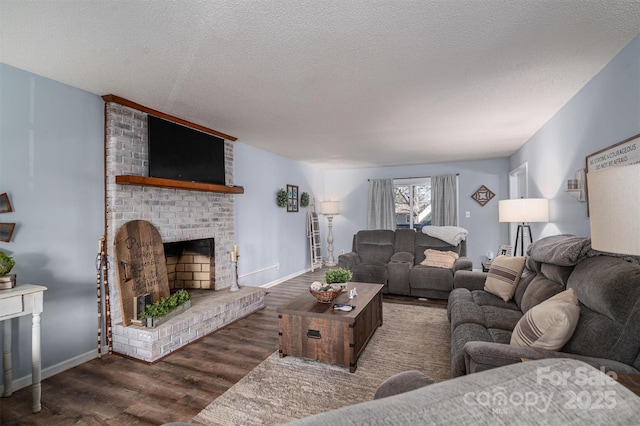 living room featuring a brick fireplace, a textured ceiling, and dark hardwood / wood-style flooring