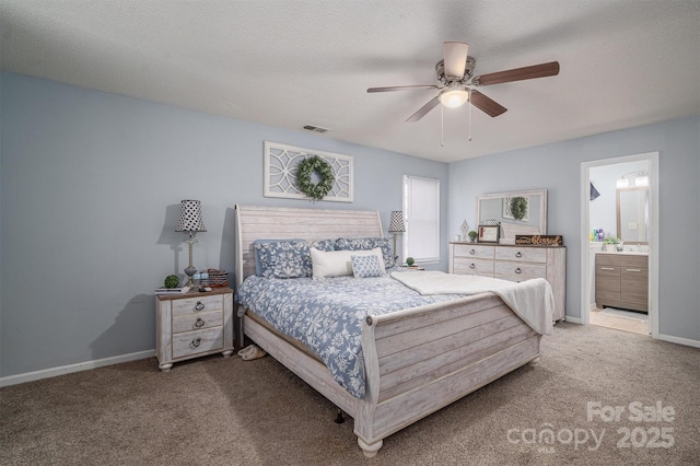 bedroom with ceiling fan, connected bathroom, carpet, and a textured ceiling