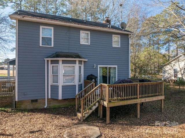 rear view of property with a wooden deck