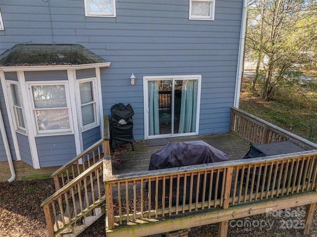 wooden deck featuring a grill