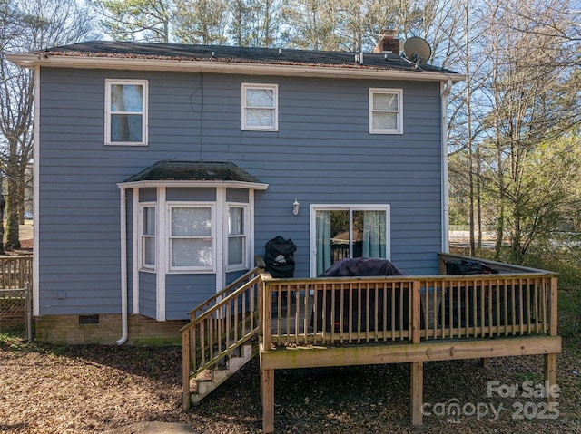 rear view of property featuring a deck