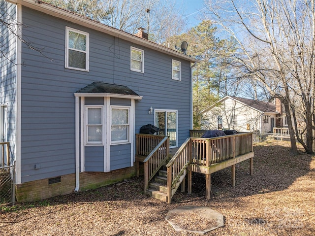 back of property with a wooden deck