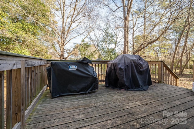 wooden deck with a grill