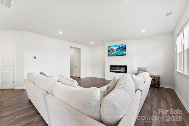 living room with dark hardwood / wood-style flooring