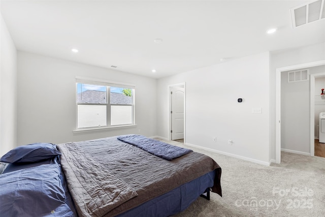 carpeted bedroom with washer / dryer