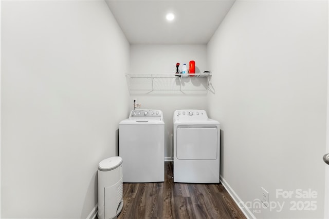 washroom with dark hardwood / wood-style flooring and washing machine and dryer