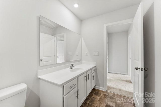 bathroom with vanity and toilet