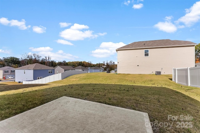 view of yard with central AC unit and a patio area