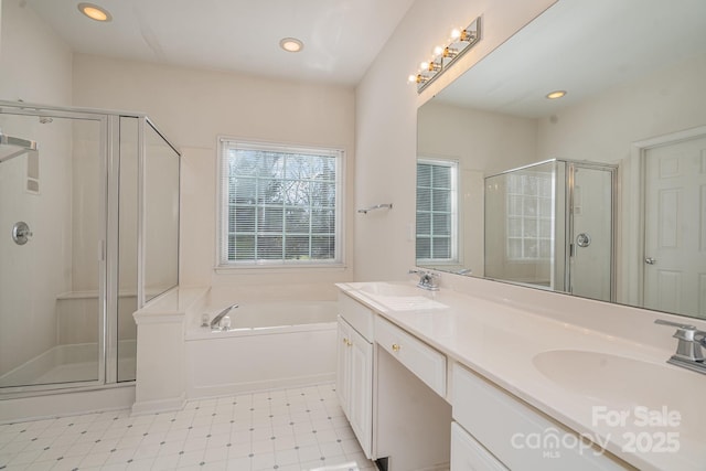 bathroom featuring vanity and independent shower and bath