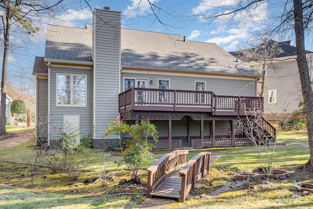 back of house featuring a wooden deck and a lawn