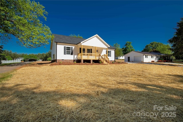 exterior space featuring a porch and a lawn