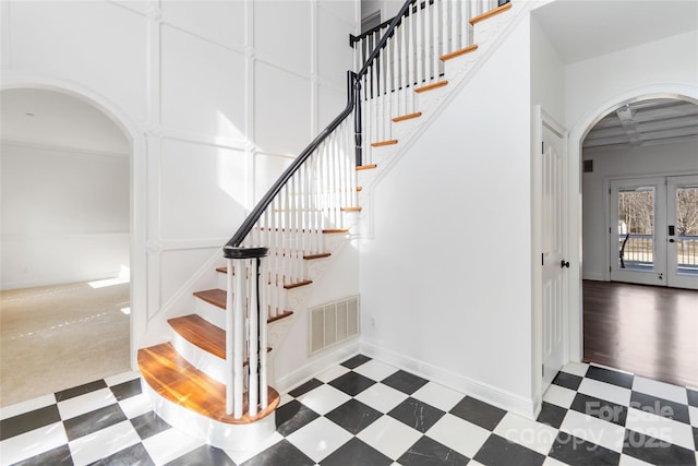 stairs featuring french doors