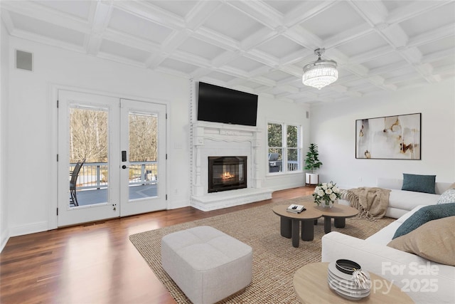 living room featuring coffered ceiling, beam ceiling, wood-type flooring, and french doors