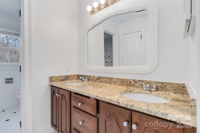 bathroom featuring vanity and toilet