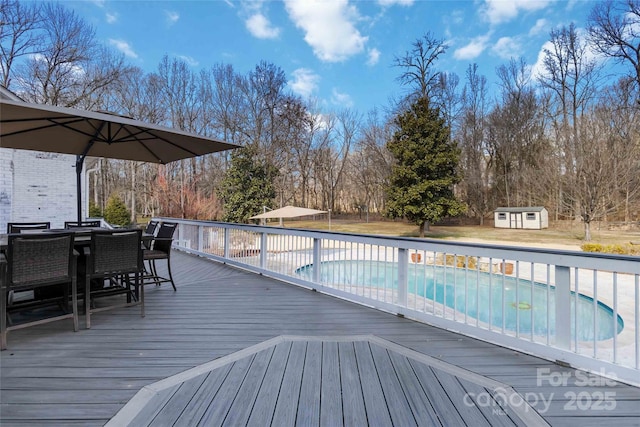 wooden deck with a storage shed