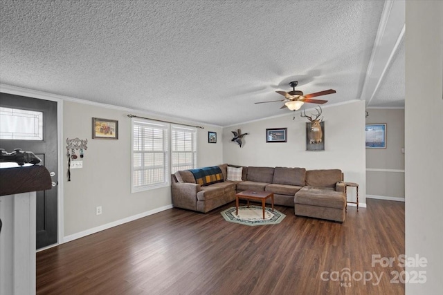 living room featuring dark hardwood / wood-style floors, lofted ceiling, ornamental molding, ceiling fan, and a textured ceiling