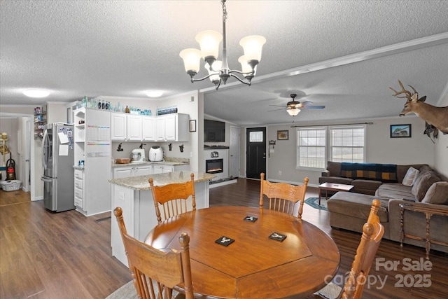 dining space featuring dark hardwood / wood-style floors, a textured ceiling, and ceiling fan