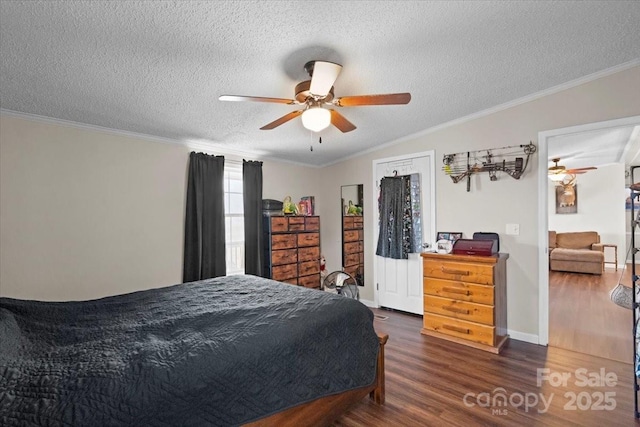 bedroom with ceiling fan, ornamental molding, dark hardwood / wood-style floors, and a textured ceiling