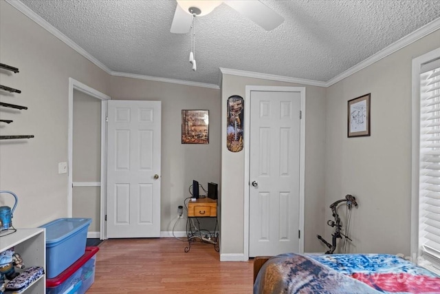 bedroom featuring crown molding, hardwood / wood-style flooring, and a textured ceiling