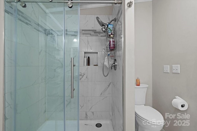 bathroom with walk in shower and toilet