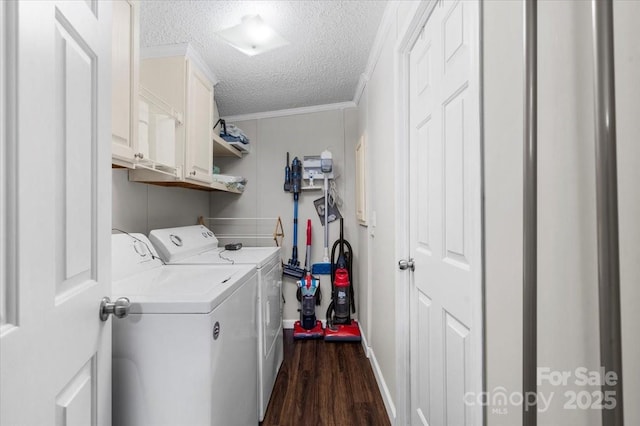 laundry room featuring crown molding, dark hardwood / wood-style flooring, cabinets, a textured ceiling, and separate washer and dryer