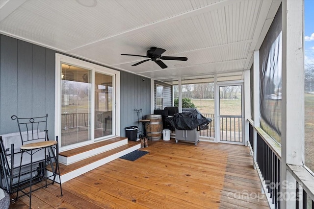 sunroom featuring ceiling fan