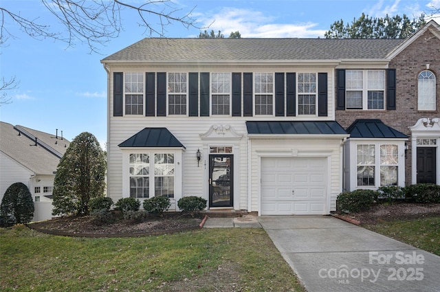 view of front of house featuring a garage and a front lawn