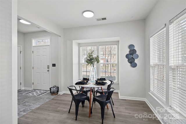 dining space with light hardwood / wood-style flooring